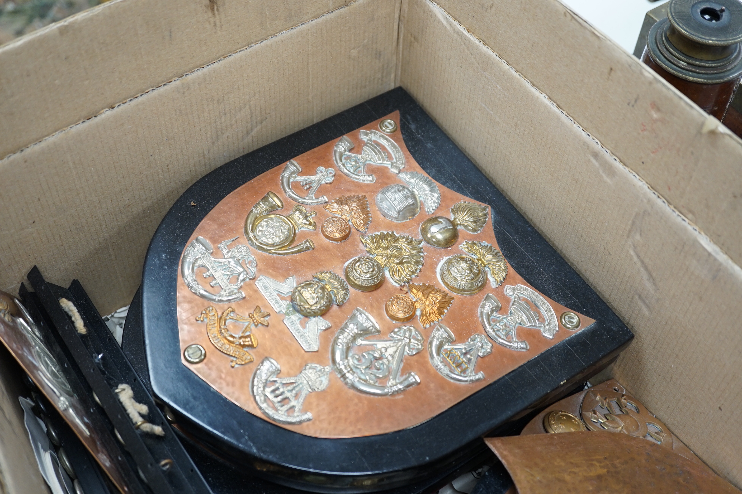 A collection of Military cap badges and buttons